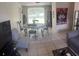 Cozy living room with neutral tones, tile floors, and comfortable seating arrangements at 2010 Warrington Way, Tampa, FL 33619