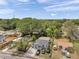 Wide aerial shot shows house placement on lot with driveway and neighborhood at 2108 E Linebaugh Ave, Tampa, FL 33612