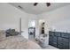 Well-lit bedroom boasts a ceiling fan, a large bed, tiled floor, and access to both the kitchen and a walk-in closet at 2108 E Linebaugh Ave, Tampa, FL 33612