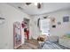Cozy bedroom offering natural light, a large mirror, storage, laminate floor, and unique wall decorations at 2108 E Linebaugh Ave, Tampa, FL 33612