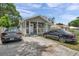 Charming single-story home with a welcoming front porch and well-maintained front yard with driveway and multiple cars at 2108 E Linebaugh Ave, Tampa, FL 33612