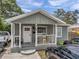 Inviting front porch with chairs and a table, perfect for relaxing and enjoying the outdoors at 2108 E Linebaugh Ave, Tampa, FL 33612