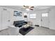 Comfortable living room with a black sofa, tile flooring, and natural light at 2108 E Linebaugh Ave, Tampa, FL 33612