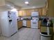 Practical kitchen with essential appliances, neutral countertops, and tiled flooring, ready for cooking at 2239 Curtis S Dr, Clearwater, FL 33764