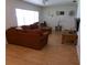 Bright living room with ample seating, laminate floors, and natural light, ideal for relaxation at 2239 Curtis S Dr, Clearwater, FL 33764