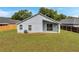 View of the home's exterior and yard, featuring a covered patio and lush green lawn at 243 Chardonnay Pl, Valrico, FL 33594