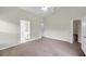 This spacious bedroom has carpeted floors, a ceiling fan, and entryways to a bathroom and closet at 243 Chardonnay Pl, Valrico, FL 33594