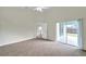 This carpeted bedroom has a sliding glass door to a backyard patio and a ceiling fan at 243 Chardonnay Pl, Valrico, FL 33594