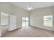 Vaulted ceiling bedroom with a ceiling fan, carpet floors, and sliding glass door access to the backyard at 243 Chardonnay Pl, Valrico, FL 33594