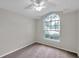 Bedroom features a large arched window, neutral paint, and carpet at 243 Chardonnay Pl, Valrico, FL 33594