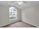 Bright bedroom features a large arched window, neutral paint, and carpet at 243 Chardonnay Pl, Valrico, FL 33594