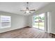 Light-filled bedroom featuring wood floors and sliding glass doors to the backyard at 243 Chardonnay Pl, Valrico, FL 33594