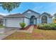 Charming single-story home features a two-car garage and well-maintained landscaping at 243 Chardonnay Pl, Valrico, FL 33594
