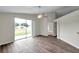 Bright living room featuring wood floors and sliding glass doors that lead to the backyard at 243 Chardonnay Pl, Valrico, FL 33594