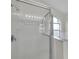 Shower with glass door and white tile, next to garden tub and arched window at 243 Chardonnay Pl, Valrico, FL 33594