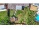Aerial view of the backyard with grass and mature landscaping, ideal for outdoor enjoyment at 245 Grove Cir N, Dunedin, FL 34698