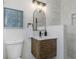 Modern bathroom with wood vanity, marble walls, and stylish fixtures at 245 Grove Cir N, Dunedin, FL 34698