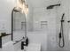 Sleek bathroom featuring marble tile, matte black fixtures, and contemporary design at 245 Grove Cir N, Dunedin, FL 34698