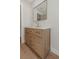 Bathroom vanity features wood cabinets, quartz countertop, a gold faucet, and a gold-framed mirror at 245 Grove Cir N, Dunedin, FL 34698