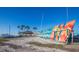 Scenic beach view with rows of colorful kayaks and a tiki hut at 245 Grove Cir N, Dunedin, FL 34698