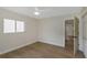 Bedroom features wood floors, a window, a ceiling fan, and a closet at 245 Grove Cir N, Dunedin, FL 34698