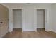Bedroom featuring a pair of closets, both with the doors open, next to an interior paneled door at 245 Grove Cir N, Dunedin, FL 34698