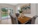Dining room featuring wood table and chairs with sliding door access to the patio and backyard at 245 Grove Cir N, Dunedin, FL 34698