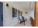 Inviting front porch with chairs, providing a cozy space to relax and enjoy the neighborhood views at 245 Grove Cir N, Dunedin, FL 34698