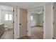 Hallway with doors leading to the bathroom and bedrooms featuring wood floors at 245 Grove Cir N, Dunedin, FL 34698