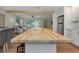 Modern kitchen with a spacious island and sleek appliances, seamlessly connecting to the living area for easy entertaining at 245 Grove Cir N, Dunedin, FL 34698