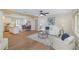 Open-concept living room with wood floors, neutral colors, and abundant natural light, creating a welcoming atmosphere at 245 Grove Cir N, Dunedin, FL 34698