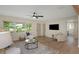 Bright and airy living room with stylish decor, wood-look flooring, and large windows, perfect for relaxing and entertaining at 245 Grove Cir N, Dunedin, FL 34698