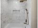 Modern shower features white marble tile, rainfall shower head, handheld sprayer, and recessed niche at 245 Grove Cir N, Dunedin, FL 34698
