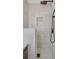 Walk-in shower with white marble tiling and modern fixtures, providing a spa-like experience at 245 Grove Cir N, Dunedin, FL 34698