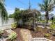 Serene backyard oasis with a wooden pergola covered in vines, creating a tranquil retreat at 2504 W North A St # A, Tampa, FL 33609