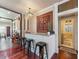 Wet bar with granite countertops and dark wood flooring that connects to a kitchen at 2504 W North A St # A, Tampa, FL 33609