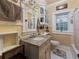Bathroom featuring a vanity, decorative mirror, and window offering natural light at 2504 W North A St # A, Tampa, FL 33609
