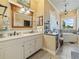 Bright bathroom featuring double sink vanity, makeup station and soaking tub by the window at 2504 W North A St # A, Tampa, FL 33609