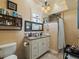 Charming bathroom features a double sink vanity, decorative mirror, and a tiled shower at 2504 W North A St # A, Tampa, FL 33609