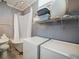 This bathroom features a classic clawfoot tub with vintage-style fixtures and modern washer and dryer at 2504 W North A St # A, Tampa, FL 33609