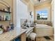 Bathroom with vanity, makeup station, granite countertop and soaking tub with natural light at 2504 W North A St # A, Tampa, FL 33609