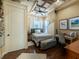 Cozy bedroom featuring a comfortable bed, a ceiling fan, and a well-lit desk area at 2504 W North A St # A, Tampa, FL 33609