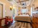 Bright bedroom featuring a coffered ceiling, wood floors, and access to an outdoor area at 2504 W North A St # A, Tampa, FL 33609