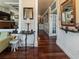 Hallway with wood floors, neutral paint, trim, and views into living room with brick fireplace at 2504 W North A St # A, Tampa, FL 33609