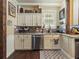 Well-lit kitchen featuring granite countertops, stainless steel appliances, and cream-colored cabinets at 2504 W North A St # A, Tampa, FL 33609
