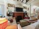 Living room showcasing a brick fireplace, hardwood floors, and a staircase with detailed trim at 2504 W North A St # A, Tampa, FL 33609