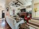Living room with fireplace and lots of natural light with an open stairway and hardwood floors at 2504 W North A St # A, Tampa, FL 33609