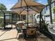 Outdoor patio with covered dining table, grill, and view of the charming home's front entrance at 2504 W North A St # A, Tampa, FL 33609