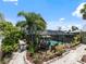 Aerial view of a screened-in pool and patio area surrounded by lush greenery and pathways at 2504 W North A St # A, Tampa, FL 33609
