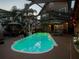 Evening view of screened-in pool with illuminated water and decorative lighting, great for relaxing at 2504 W North A St # A, Tampa, FL 33609